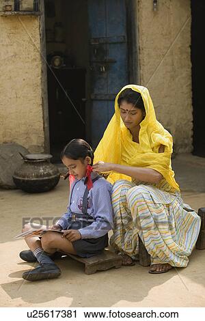 Stock Image - A rural mother sitting with her daughter. Fotosearch