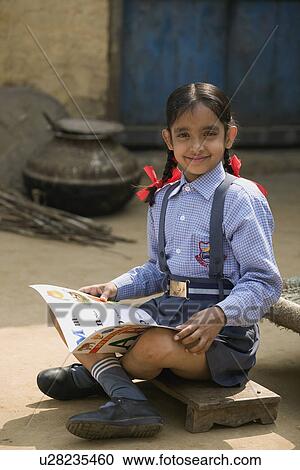 A rural school girl sitting with her boo View Large Photo Image Stock Image - A rural school girl sitting with her boo. Fotosearch