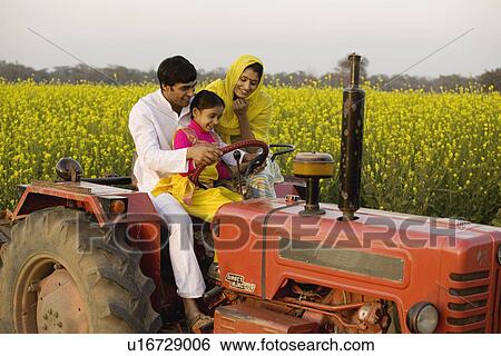 Stock Photograph - A typical rural family on a tractor. Fotosearch