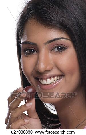 A woman holding a grape View Large Photo Image Stock Image - A woman holding a grape. Fotosearch