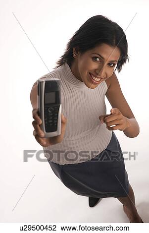 Stock Image - A woman holding a mobile phone. Fotosearch