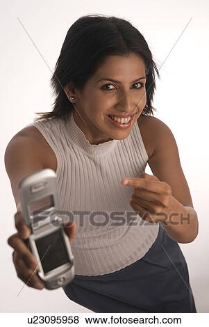 A woman holding a mobile phone View Large Photo Image Stock Photo - A woman holding a mobile phone. Fotosearch