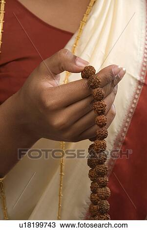 A woman holding a rosary View Large Photo Image Stock Image - A woman holding a rosary. Fotosearch