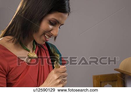 A woman offering flowers View Large Photo Image Stock Photo - A woman offering flowers. Fotosearch