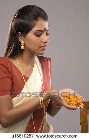 Stock Photo - A woman offering flowers. Fotosearch