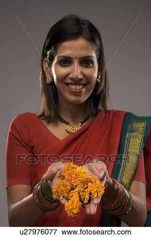Stock Photo - A woman offering flowers. Fotosearch