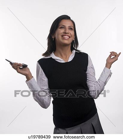 A woman talking on a mobile phone View Large Photo Image Stock Photo - A woman talking on a mobile phone. Fotosearch