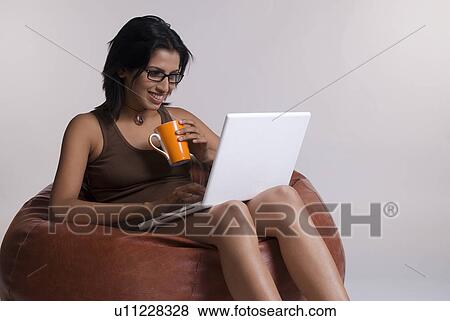 A woman working on a laptop View Large Photo Image Stock Photo - A woman working on a laptop. Fotosearch
