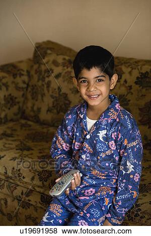 Stock Photo - A young boy holding a remote. Fotosearch