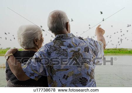 Stock Photo - An old couple enjoying. Fotosearch