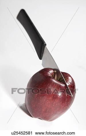Stock Image - Apple with a knife. Fotosearch