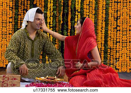 Stock Photography - Applying a tika. Fotosearch