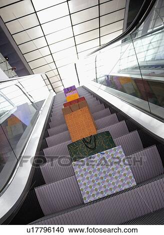 Stock Image - Bags on escalator. Fotosearch