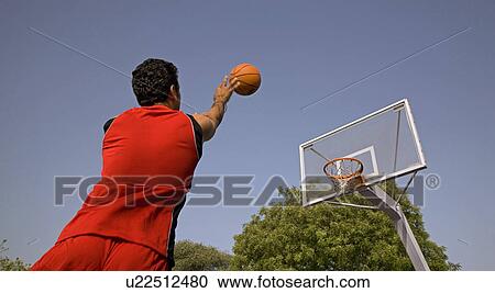 Stock Image - Basketball player makes a shot. Fotosearch