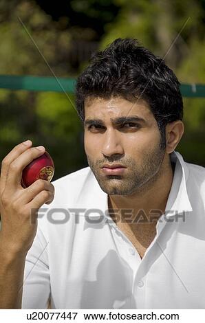 Bowler checking the cricket ball View Large Photo Image Stock Photo - Bowler checking the cricket ball. Fotosearch