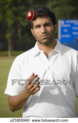 Bowler tossing cricket ball in air View Large Photo Image Stock Image - Bowler tossing cricket ball in air. Fotosearch