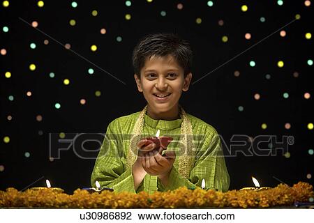 Boy holding Diya View Large Photo Image Stock Image - Boy holding Diya. Fotosearch
