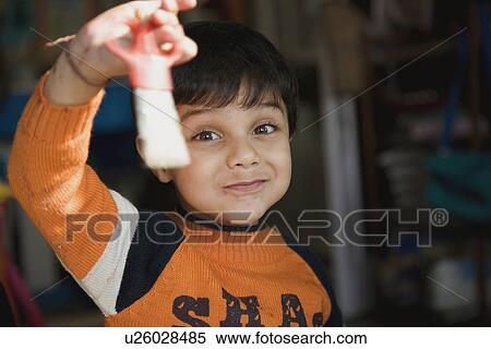 Stock Photography - Boy holding scissors. Fotosearch