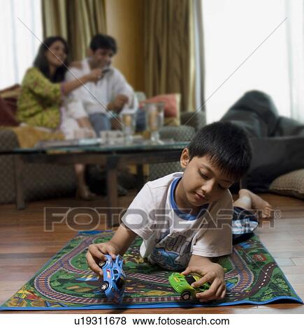 Boy playing in living room View Large Photo Image Stock Photo - Boy playing in living room. Fotosearch