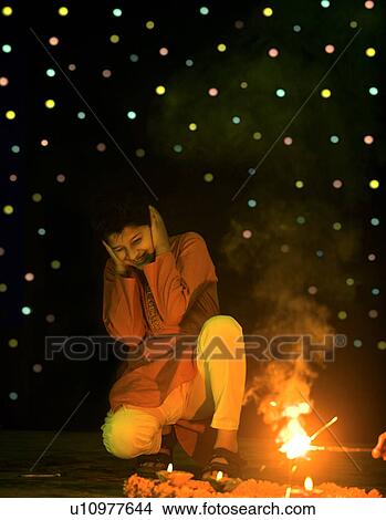 Picture - Boy scared by crackers. Fotosearch