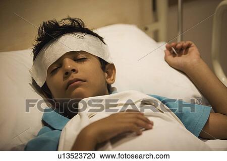 Boy sleeping with a damp cloth on his forehead View Large Photo Image Stock Image - Boy sleeping with a damp cloth on his forehead. Fotosearch
