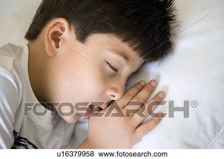 Stock Photo - Boy sleeping with the thumb in his mouth. Fotosearch