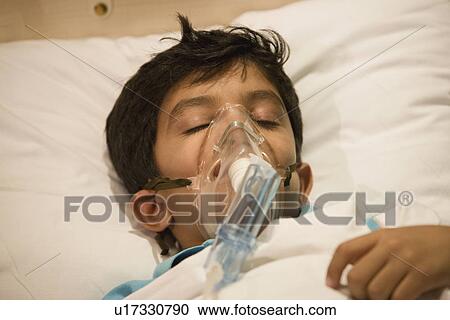 Stock Image - Boy with oxygen mask. Fotosearch
