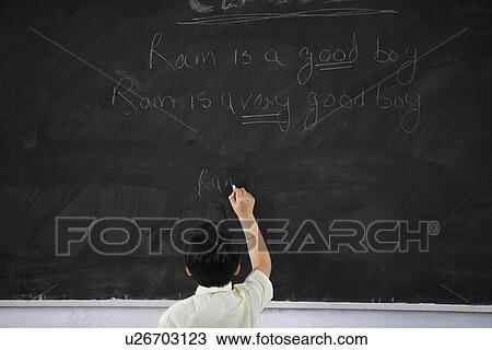 Boy writing on a black board View Large Photo Image Stock Image - Boy writing on a black board. Fotosearch