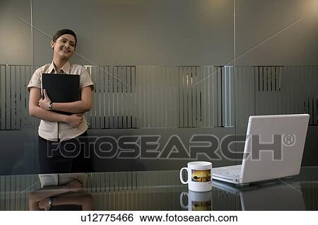 Business executive holding a file View Large Photo Image Stock Photograph - Business executive holding a file. Fotosearch