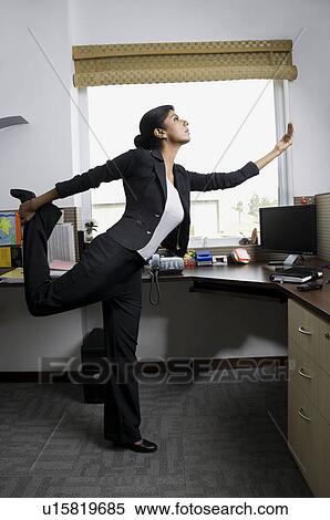 Stock Photography - Business executive in a yoga position. Fotosearch
