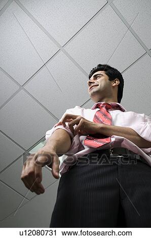 Stock Image - Business executive rolling up his sleeve. Fotosearch