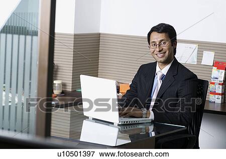 Stock Photo - Business executive with a laptop. Fotosearch