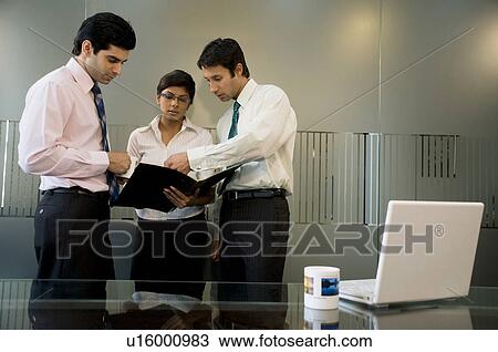 Stock Image - Business executives discussing. Fotosearch