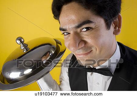 Butler holding a tray View Large Photo Image Stock Photo - Butler holding a tray. Fotosearch