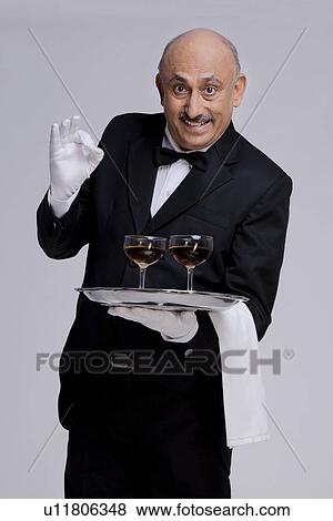 Stock Photo - Butler holding some drinks. Fotosearch