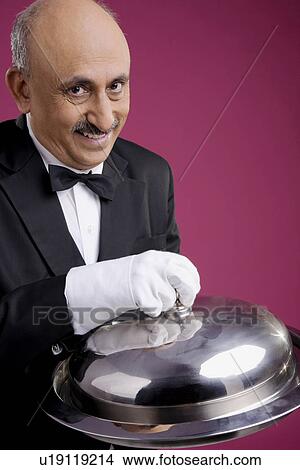 Picture - Butler with serving platter. Fotosearch