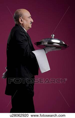 Butler with serving platter View Large Photo Image Stock Image - Butler with serving platter. Fotosearch