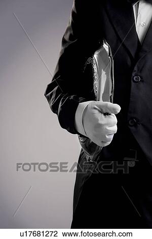 Stock Image - Carrying a tray. Fotosearch