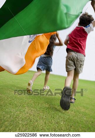 Stock Photograph - Children running with the Indian Flag. Fotosearch