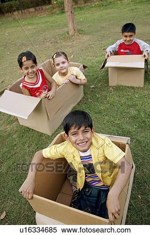 Children sitting in boxes View Large Photo Image Stock Photography - Children sitting in boxes. Fotosearch