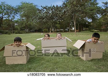 Stock Photography - Children sitting in boxes. Fotosearch