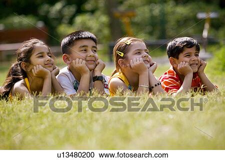 Stock Image - Children with hands under their chin. Fotosearch