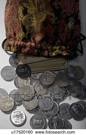 Stock Image - Coins and currency notes. Fotosearch
