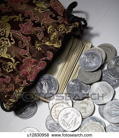 Stock Photo - Coins and currency notes. Fotosearch