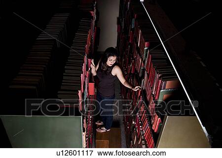 Stock Photo - College student in the library. Fotosearch