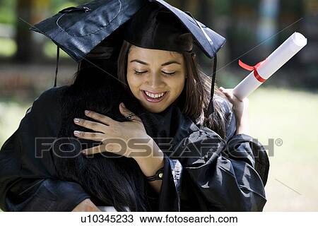 Stock Image - College students at graduation ceremony. Fotosearch