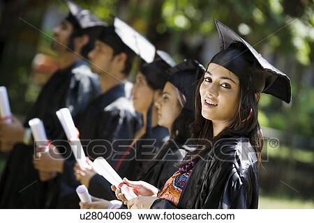 Stock Photo - College students at graduation ceremony. Fotosearch