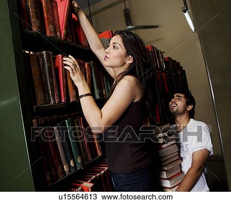 Stock Image - College students in the library. Fotosearch