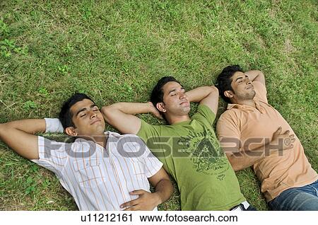 Stock Image - College students taking a nap. Fotosearch