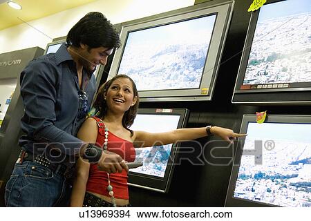 Picture - Couple at TV showroom. Fotosearch